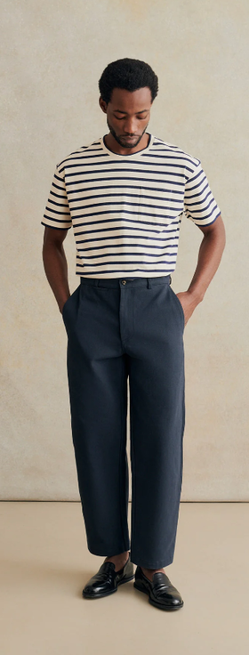 A man wearing De Bonne Facture stripe oversized t-shirt