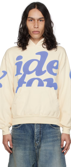 A man wearing VIDEO STORE APPAREL video store apparel off-white mega puff hoodie