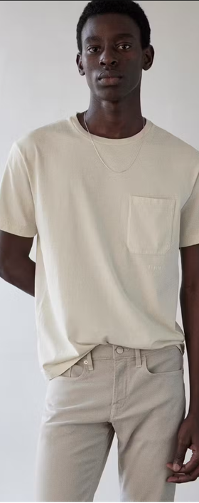 A man wearing Frame jeans vintage tee in white sand