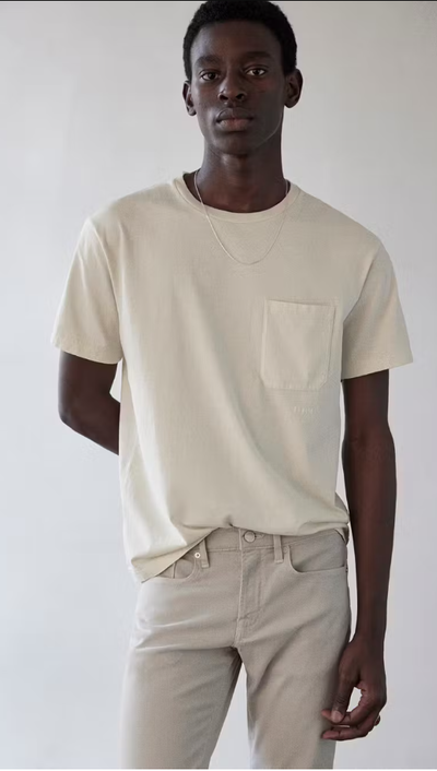 A man wearing Frame jeans vintage tee in white sand