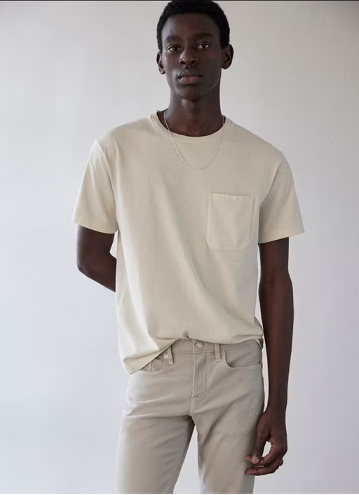A man wearing Frame jeans vintage tee in white sand