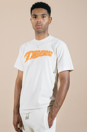 A man wearing Fat Tiger Workshop white t-shirt