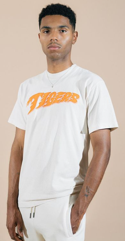 A man wearing Fat Tiger Workshop white t-shirt