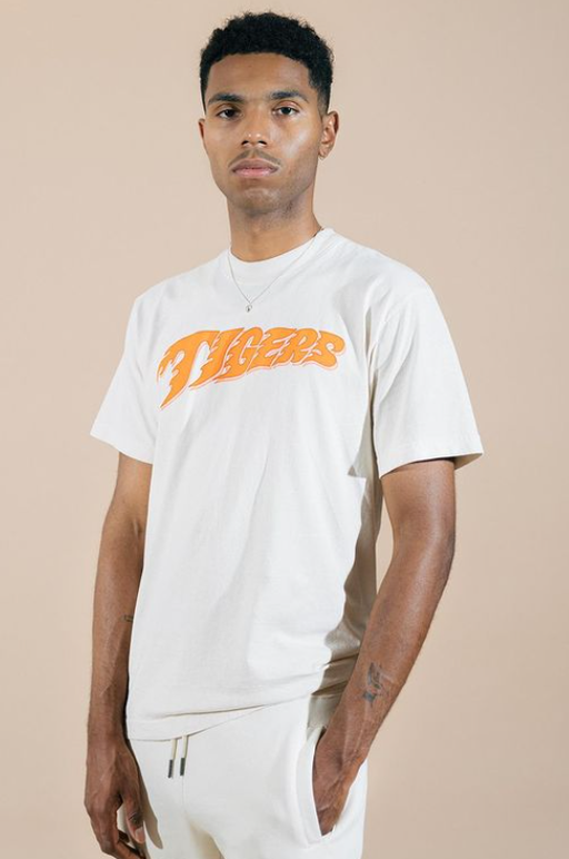 A man wearing Fat Tiger Workshop white t-shirt