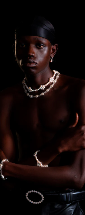 A man wearing a Hatton Labs mint daisy pearl chain