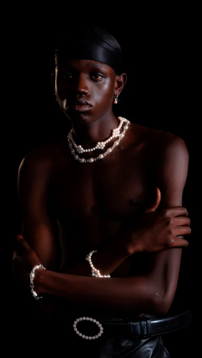 A man wearing a Hatton Labs mint daisy pearl chain