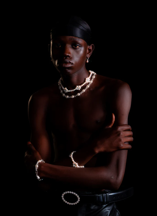 A man wearing a Hatton Labs mint daisy pearl chain