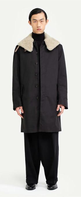 A man wearing Norwegian Rain black raincoat
