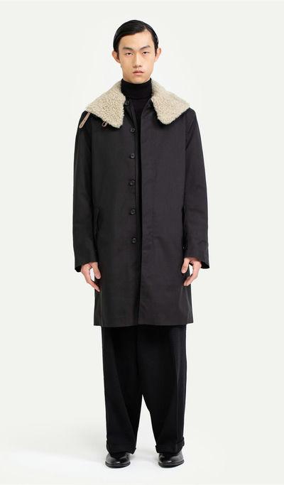 A man wearing Norwegian Rain black raincoat