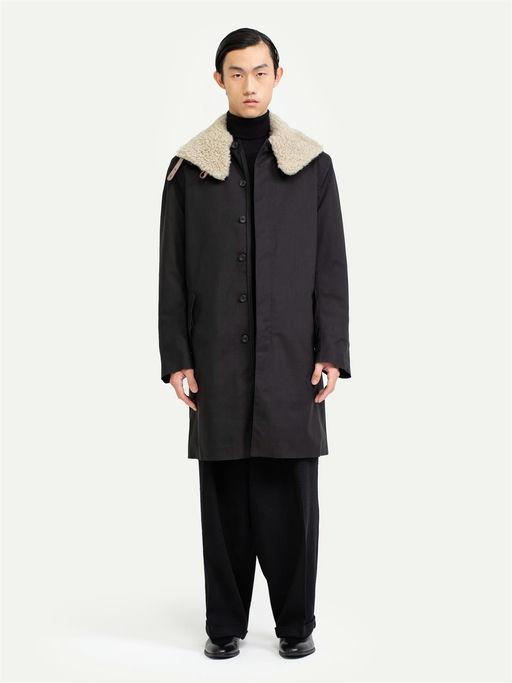 A man wearing Norwegian Rain black raincoat
