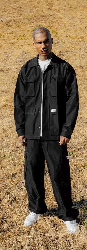 A man wearing pro club men's heavyweight safari jacket - black