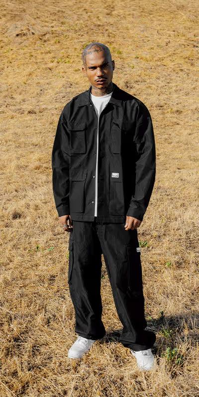 A man wearing pro club men's heavyweight safari jacket - black