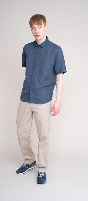 A man wearing JohnnyLove blue short sleeved shirt