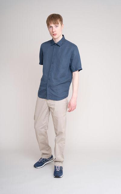 A man wearing JohnnyLove blue short sleeved shirt