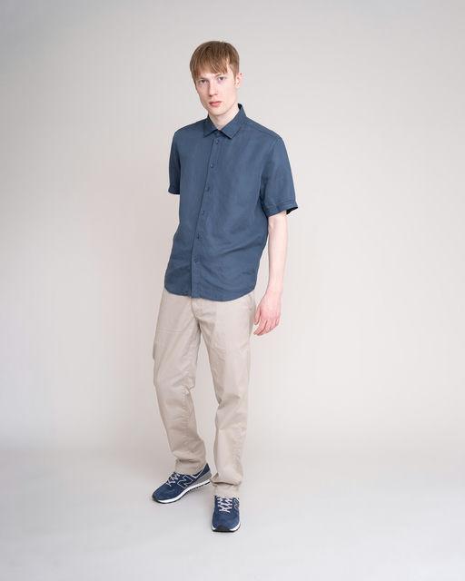 A man wearing JohnnyLove blue short sleeved shirt
