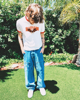 A man wearing Ransom screamin eagle ringer tee