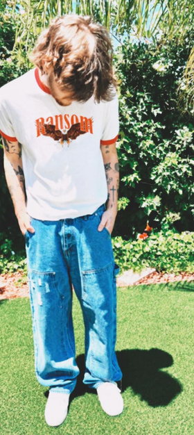 A man wearing Ransom screamin eagle ringer tee