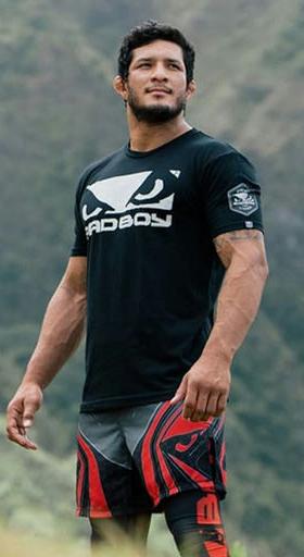A man wearing a bad boy boxing shirt in black