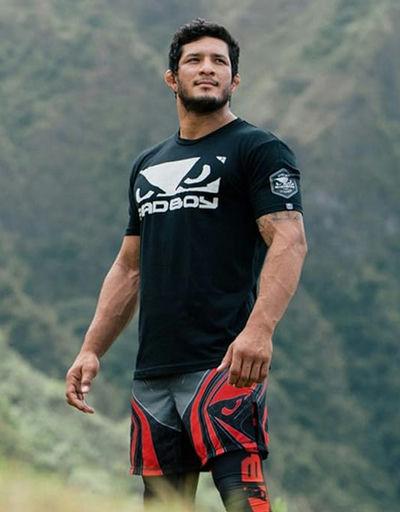 A man wearing a bad boy boxing shirt in black