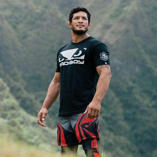 A man wearing a bad boy boxing shirt in black