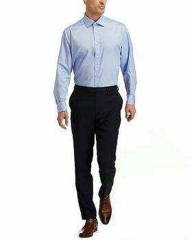 A man wearing Hickey Freeman modern fit spread collar solid dress shirt - blue