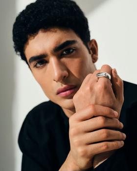 A man wearing Tom Wood crest ring
