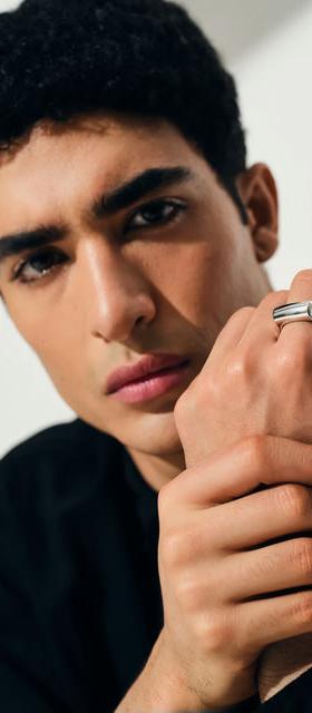 A man wearing Tom Wood crest ring
