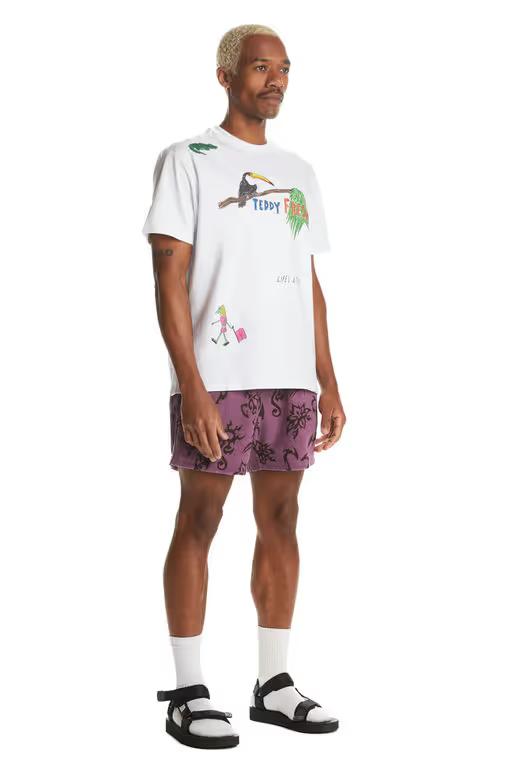A man wearing Teddy Fresh white iguana tee