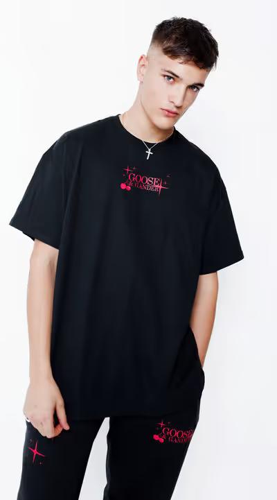 A man wearing goose and gander unisex black cherry tee