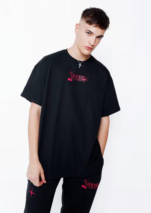 A man wearing goose and gander unisex black cherry tee