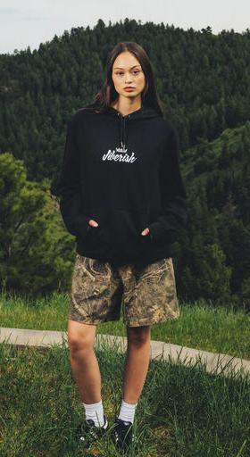 A woman wearing Jiberish Boston Store script french terry hoodie black