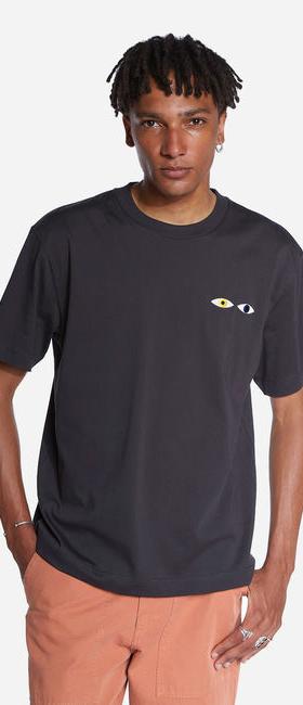 A man wearing Olow oversized black different tee shirt