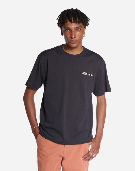 A man wearing Olow oversized black different tee shirt