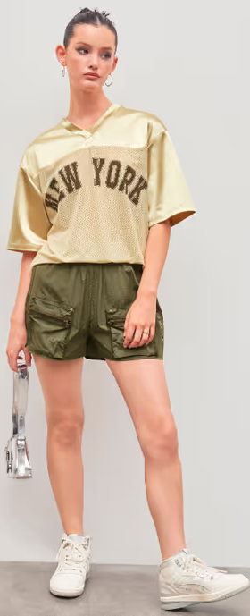 A woman wearing Cider new york satin v-neck oversized short sleeve gold tee