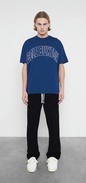 A man wearing Cole Buxton varsity arch outline  navy t-shirt