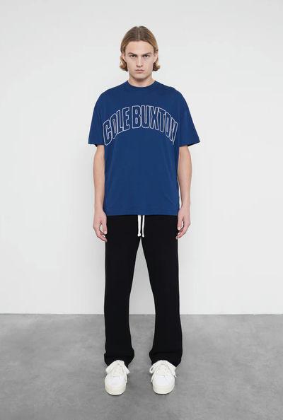 A man wearing Cole Buxton varsity arch outline  navy t-shirt