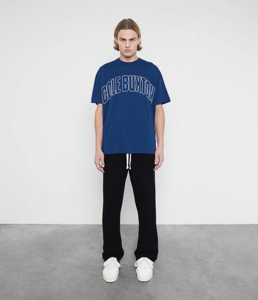 A man wearing Cole Buxton varsity arch outline  navy t-shirt