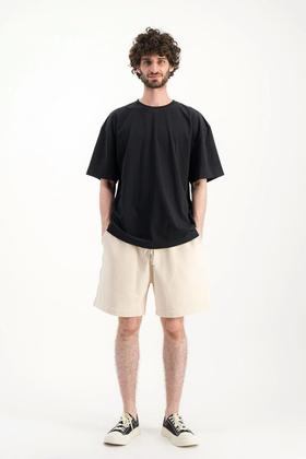 A man wearing Parages black t-shirt big t noir