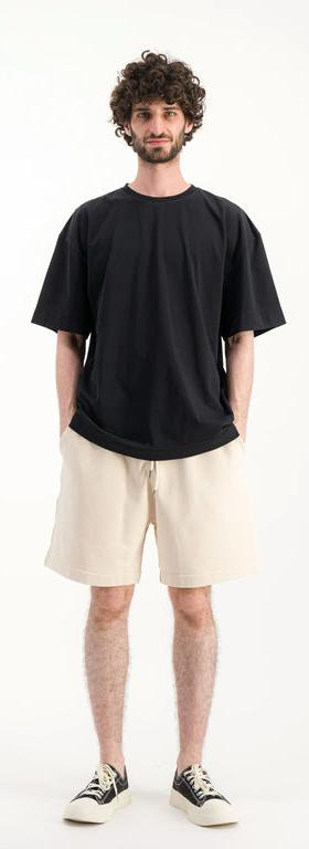 A man wearing Parages black t-shirt big t noir