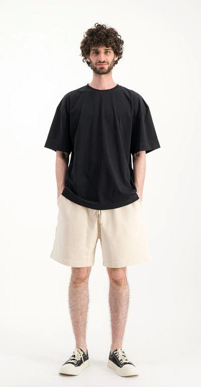 A man wearing Parages black t-shirt big t noir