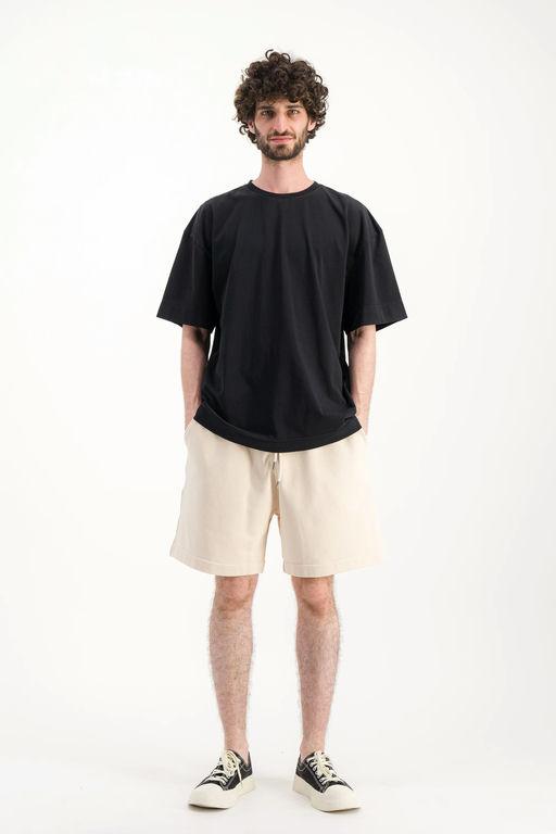 A man wearing Parages black t-shirt big t noir