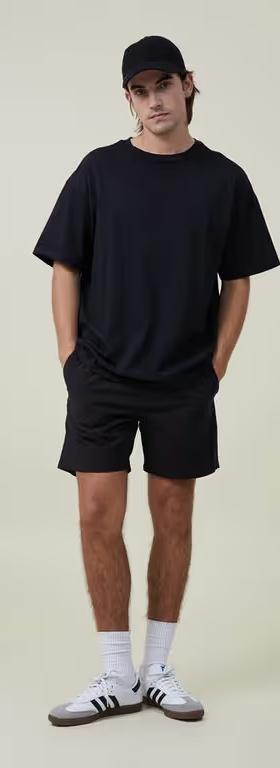 A man wearing Cotton On black easy short