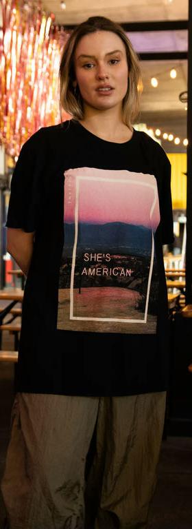 A woman wearing Daisy Street the 1975 black she's american print
