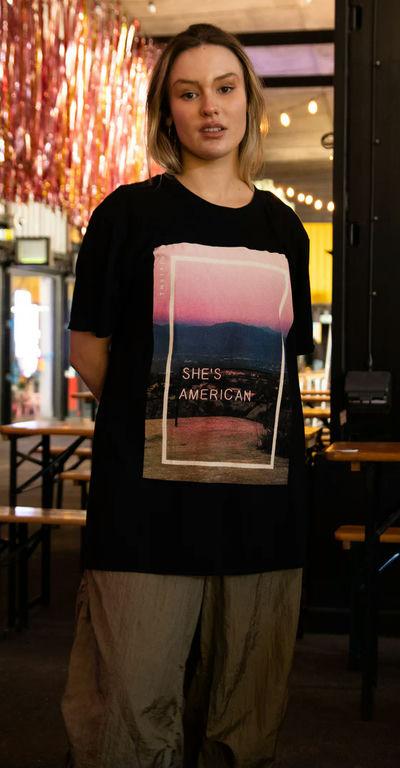 A woman wearing Daisy Street the 1975 black she's american print
