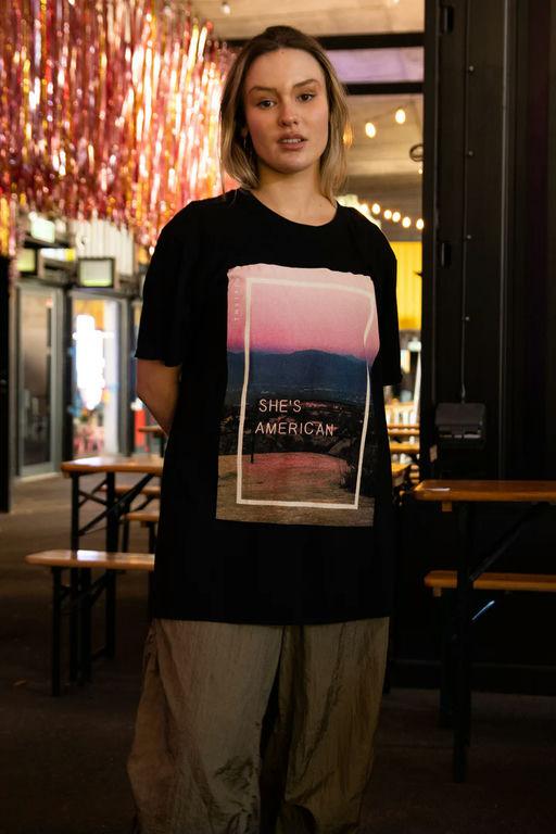 A woman wearing Daisy Street the 1975 black she's american print