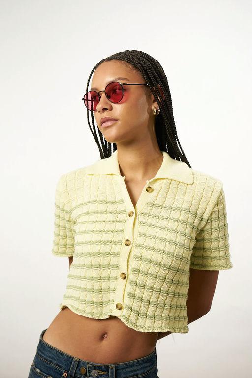 A woman wearing Akila Glasses black/rose club 57 x keith haring sunglass
