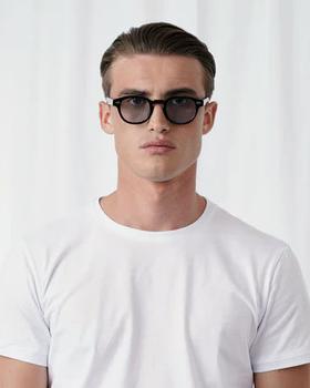A man wearing Explicit Poets tinted johnny sunglass