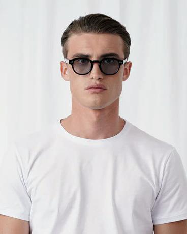 A man wearing Explicit Poets tinted johnny sunglass