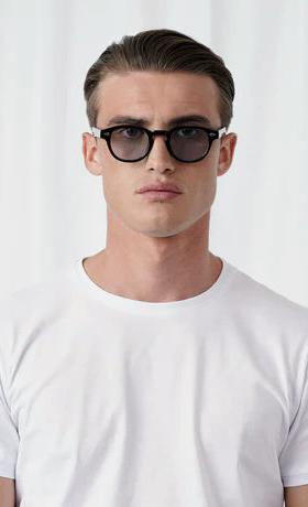 A man wearing Explicit Poets tinted johnny sunglass