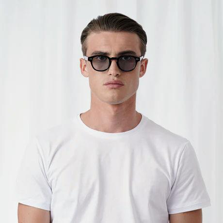 A man wearing Explicit Poets tinted johnny sunglass